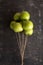 Bunch of green apples on a string like air balloons. Selective focus