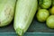 A bunch of green immature tomatoes and zucchini