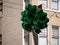 Bunch of happy St Patrick s Day green shamrock balloons floating in city
