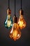 A bunch of isolated Vintage multi color light bulbs hanging from a ceiling. Panoramic image