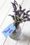 Bunch of lavender in a glass lantern jar,  with thank you written on a blue gift label.