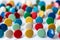 Bunch of many colorful thumbtacks as multi-color office supply metal pushpins circles in yellow, green, blue, red and white desk