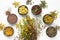 Bunch of medicinal plants and bowls of dry medicinal herbs on white background. Top view, flat lay.