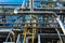 A bunch of metal pipes are standing at a gas processing plant