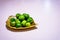 bunch of mini kiwis on a golden metal leaf plate isolated