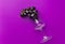 Bunch of moon drops dark purple grapes drinking glass on lilac background. Wine production harvest local artisan produce concept