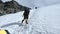 Bunch of mountaineers climbs or alpinists to the top of a snow-capped mountain