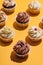 Bunch of muffins on yellow background.