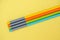 Bunch the multicolour wooden pencils isolated in yellow background