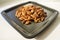 A bunch of nuts pecan on a black plate. Close-up photo