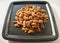 A bunch of nuts pecan on a black plate. Close-up photo