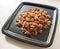 A bunch of nuts pecan on a black plate. Close-up photo