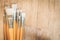 Bunch of old artist paintbrushes on wooden rustic table with space for text