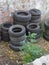 A bunch of old tyres piled up at the scrapyard