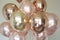 Bunch of pink and gold chrome balloon. Generative AI