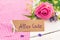 Bunch of pink rose flower with greeting card with german text, Alles Gute, means best whishes