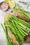 Bunch of raw asparagus stems with different spices