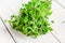 Bunch of raw green herb marjoram on a white wooden table