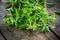 Bunch of raw green herb marjoram on a wooden table