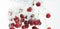 Bunch of red cherries splashing into crystal clear water with air bubbles. I