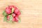 Bunch or red radishes on a bamboo board