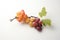 Bunch of red and yellow grapes on white background with green leaves, Two peaches and grapes branch on white background, AI