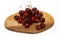 A bunch of ripe cherries with peduncles lies on a white background. Large collection of fresh red cherries. Ripe cherries