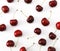 A bunch of ripe cherries with peduncles lies on a white background. Large collection of fresh red cherries. Ripe cherries