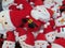 A bunch of Santa Claus Father Christmas plush soft toys on display