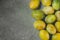 Bunch of scattered ripe juicy yellow and green plums arranged in border on dark stone background.Autumn fall harvest, Thanksgiving