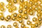 Bunch shiny golden color fake jewel round beads threads with macro view