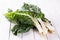 Bunch of silverbeet on a white wooden table