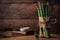 Bunch of sparrow grass on top of a chopping board