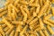 Bunch of sprial golden colored macaroni pasta