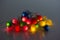 Bunch of tangled lit small colorful decoration lights close up studio shot isolated on dark gray background