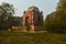 Bunch of trees and mesmerizing view of humayun tomb memorial from the side of the lawn at winter foggy morning