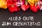 Bunch of tulips with blackboard: happy birthday in German language