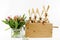 A bunch of tulips and easter rabbits in a wooden box