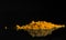 A bunch of turmeric isolated on a black background. Fragrant spice