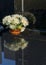 Bunch of white Chrysanthemum in flowerpot on grave