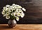 A bunch of white daisy flowers on rustic chalkboard table surface, with blur copy space background.