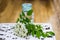 bunch of white flowers acacia near bottle of medicine. Collection of herbs in season. Branches of black locust, Robinia