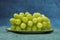 bunch of white italian dessert grapes. Image with various shades of green