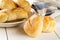 Bunch of whole, fresh baked wheat buns on plate with kitchen tow