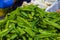 A bunch of Winged bean or goa beans on the counter of a vegetable seller counter in a fresh market in Kuala Lumpur, Malaysia. Also