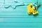 Bunch of yellow daffodisl flowers on turquoise wooden backgrou