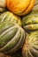 A bunch of yellow and green pumpkins on the counter. Close-up. Vertical. Soft focus