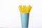 Bunch of yellow plastic straws in blue disposable biodegradable paper cup