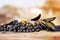 Bunches of black chokeberry Aronia melanocarpa on an old wood surface, soft focus.