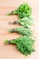 Bunches of fresh dill, thyme, mint and parsley on a light woode